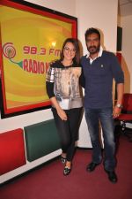 Sonakshi Sinha & Ajay Devgn at Radio Mirchi Mumbai studio for the promotion of upcoming movie Action Jackson (2)_547ea4b36cea3.JPG