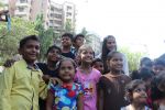  Poonam Pandey Distribute Raincoat To Neddy Kids on 30th May 2017 (21)_592ebefe19a51.JPG