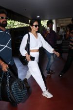 Malaika Arora in white wearing dark glasses white sneakers and holding black Chanel Bag  (11)_647447516d3c3.jpg