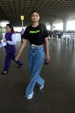 Athiya Shetty wearing black FCUK Logo crop top, Michellecmm high waist baggy blue jeans tagging Goyard Canvas Leather Purse (1)_64787197e7bca.jpg