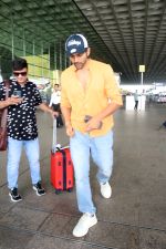 Kartik Aaryan dressed in orange shirt and blue shredded jeans and Dallas Cowboys hat seen at the airport on 25 Jun 2023 (11)_649821a522dbc.JPG