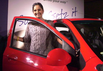 Sania Mirza poses with a Hyundai Getz car as she becomes the brand ambassadress of Hyundai Getz model
