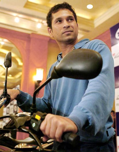 Sachin Tendulkar poses for photographers during a promotional event for a motorcycle company in Mumbai.