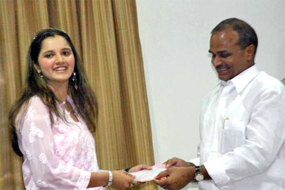 Andhra Pradesh Chief Minister YS Rajsheker Reddy presenting a cheque of Rs 20 lakh to tennis star Sania Mirza