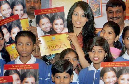 Bipasha Basu poses with young orphans