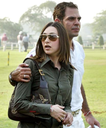Karishma Kapoor and her husband Sunjay Kapur arrive for a polo match in New Delhi.