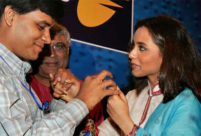 Rani Mukherjee interacts with a visually impaired man