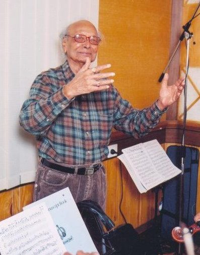 Naushad directing the musicians in the recording studio