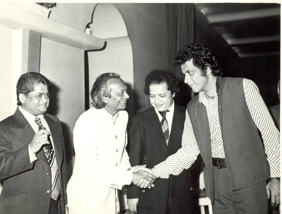Naushad shaking hands with Manoj Kumar and Laxmikant Pyarelal
