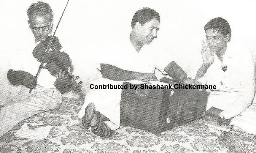 Shankar discussing a song with Shailendra & a violinst