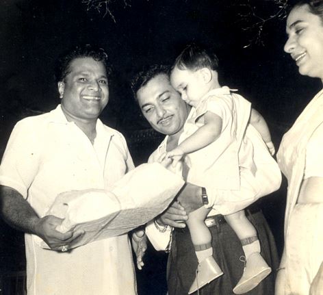 Vasantdesai giving gift to Madanmohan's son in a birthday party