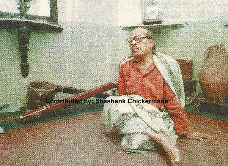 Mannadey sitting in his music room in the house