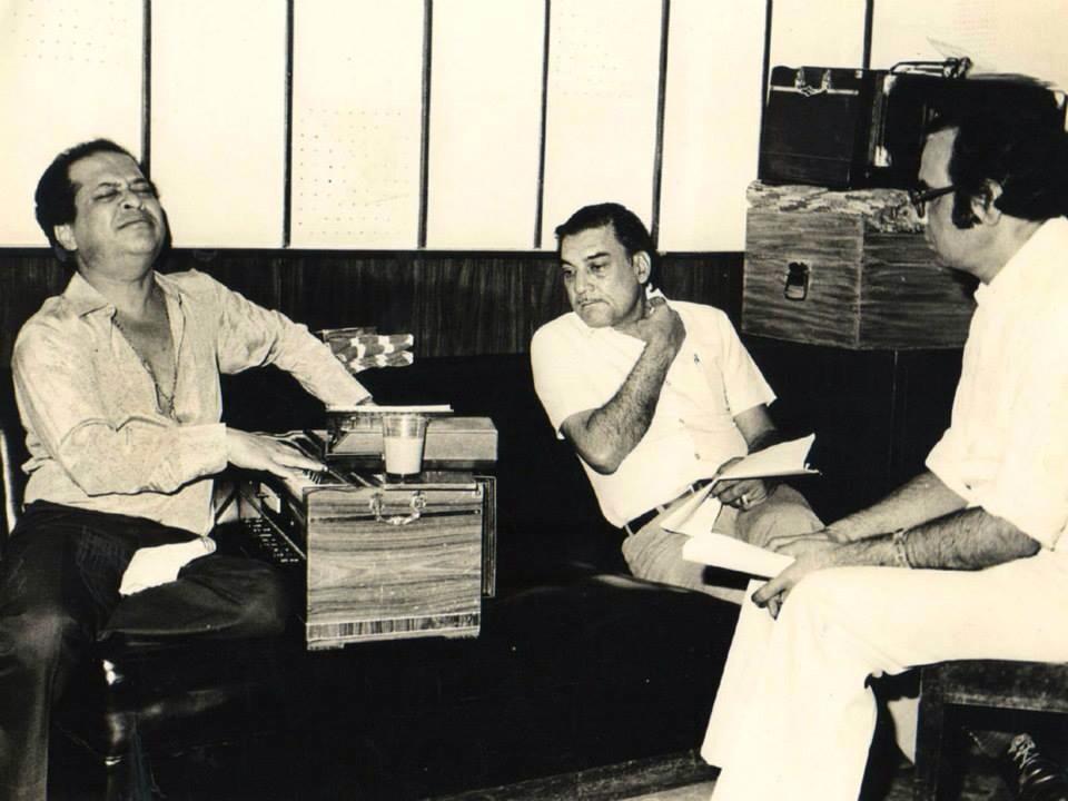 Laxmikant rehearsalling a song with his harmonium to producers in the recording studio