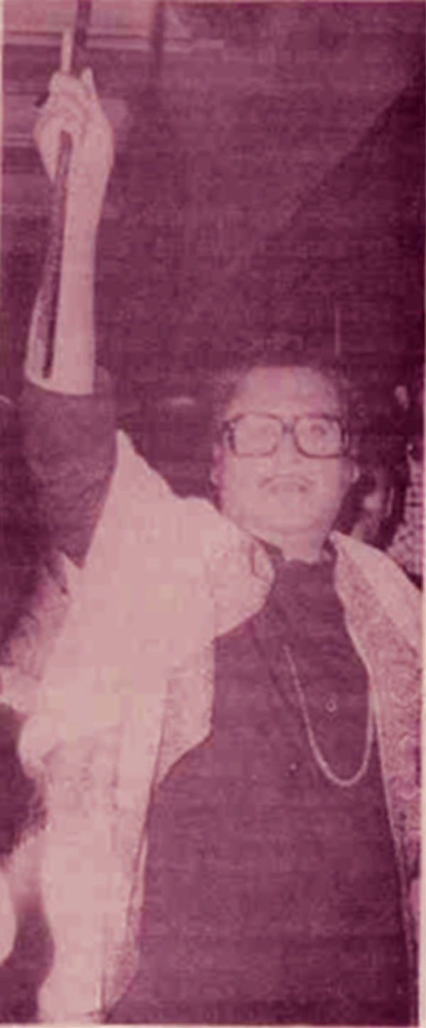 Kishore kumar holding a Flute high in the air