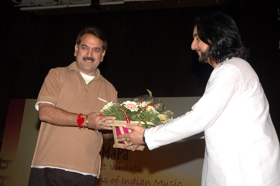 Pt. Bhajan Sopori facilitating Jugal Kishore with flowers