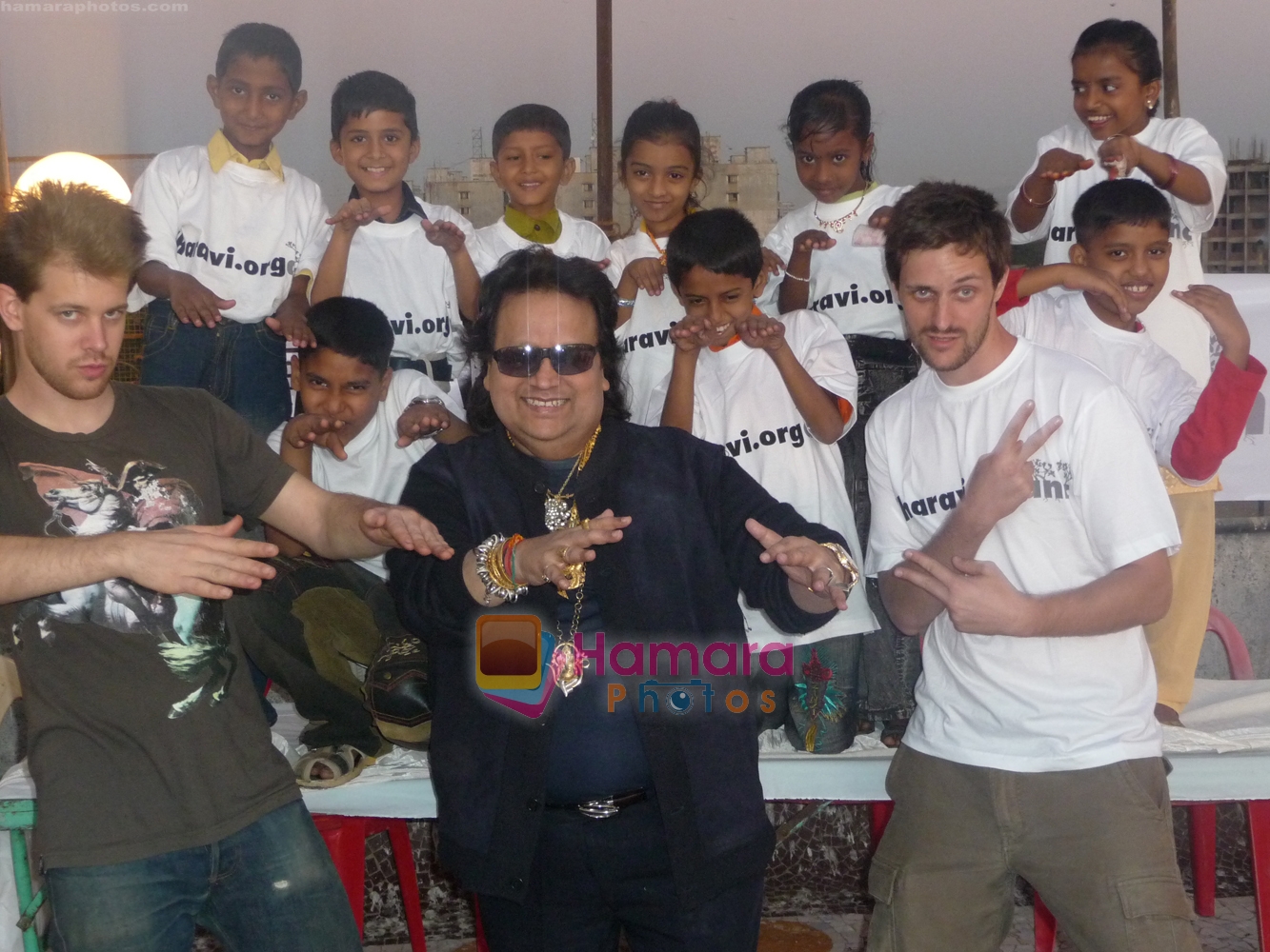 Bappi Lahiri,  DJ Paul Devro and Matias Echanowe with kids at Bappi Da and the Slum Stars Event
