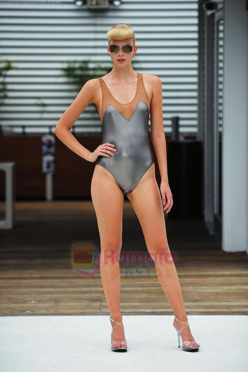 A model walks the runway during the Norma Kamali Swimwear show at Mercedes-Benz Fashion Week Swim 2012 at High Bar Rooftop on July 17, 2011 in Miami, Florida