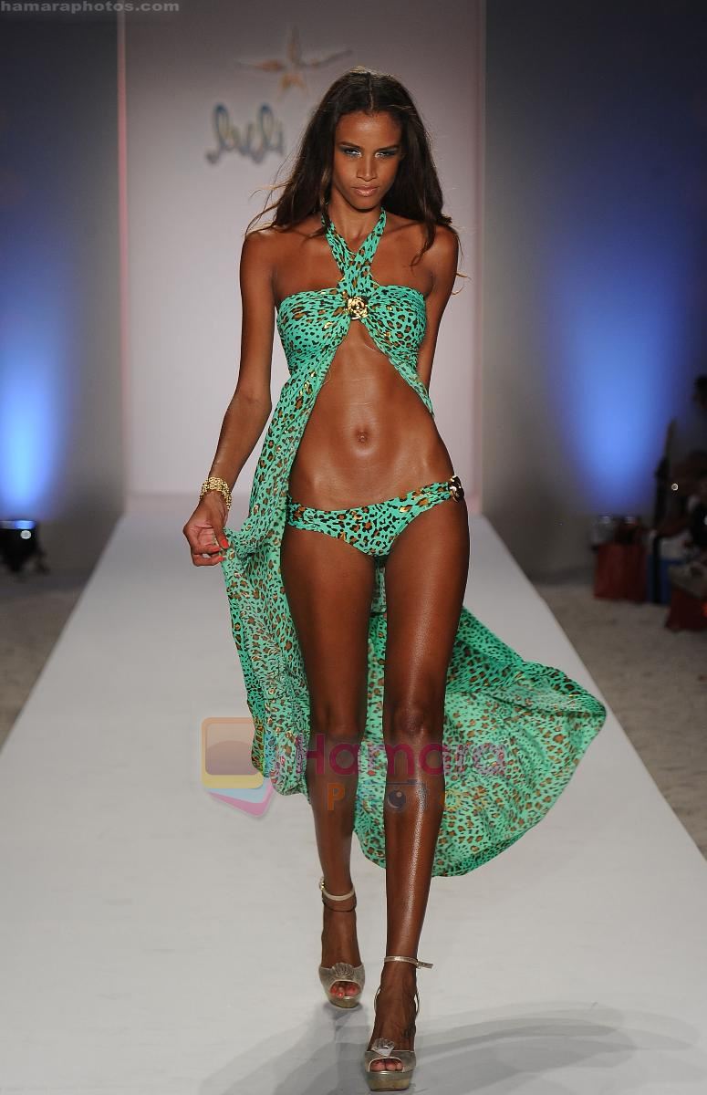 A model walks the runway at the Luli Fama show during Mercedes-Benz Fashion Week Swim 2012 at The Raleigh on July 17, 2011 in Miami Beach, Florida