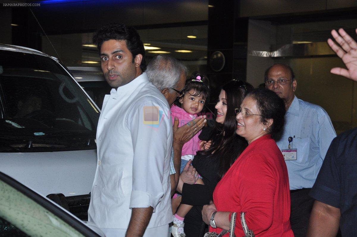Abhishek Bachchan receives Aishwarya Bachchan as she arrives from London in Mumbai on 26th June 2013