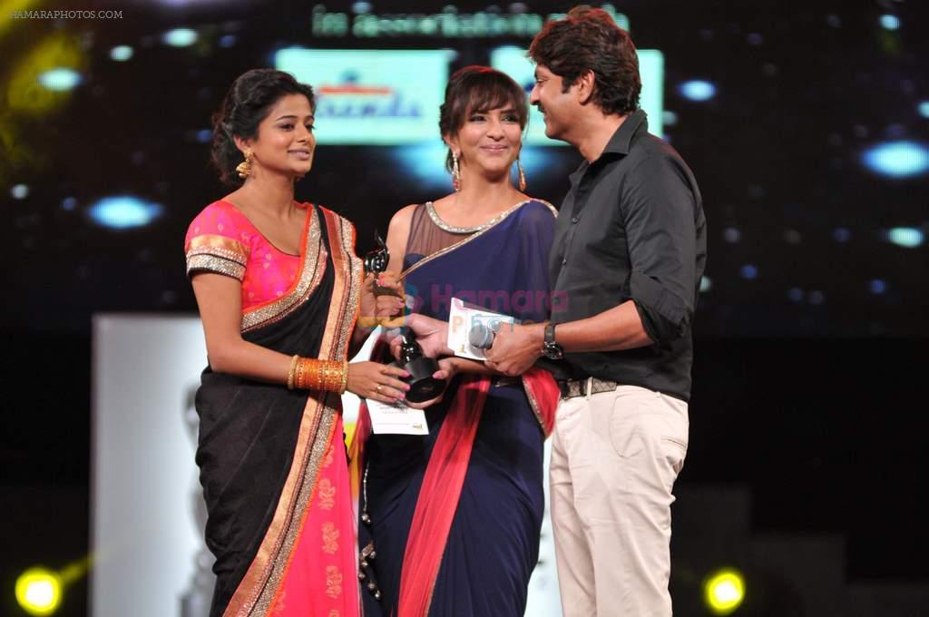 Priyamani receives the Best Actor - Female award for the movie Charulatha from Lakshmi Manchu and Jagapathy Babu during the 60th Filmfare Awards