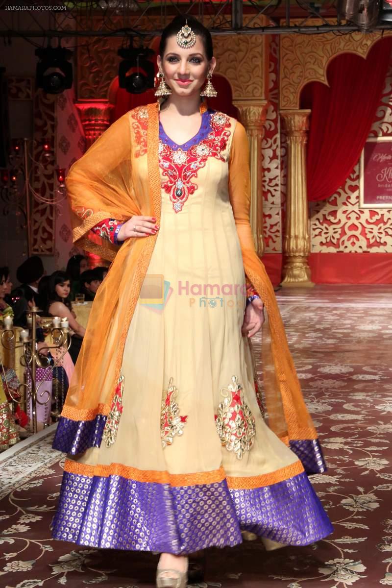 Model walks on ramp & presenting Wedding collection designed by Kavita and Meenu during a fashion show on 25th dec 2013