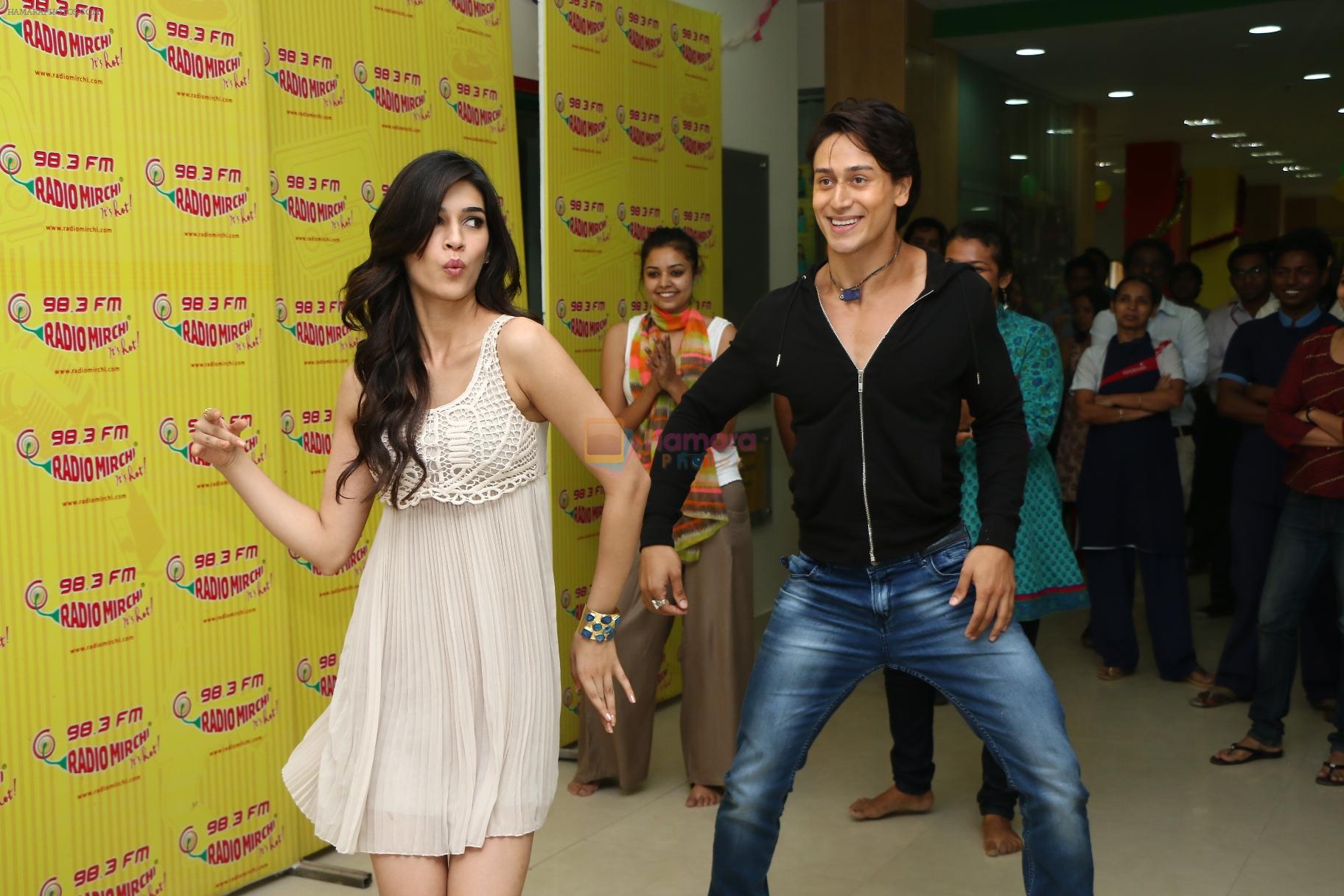 Tiger Shroff and Kriti Sanon doing the Wistle Dance at Radio Mirchi Mumbai studio during the promotion of their upcoming movie Heropanti