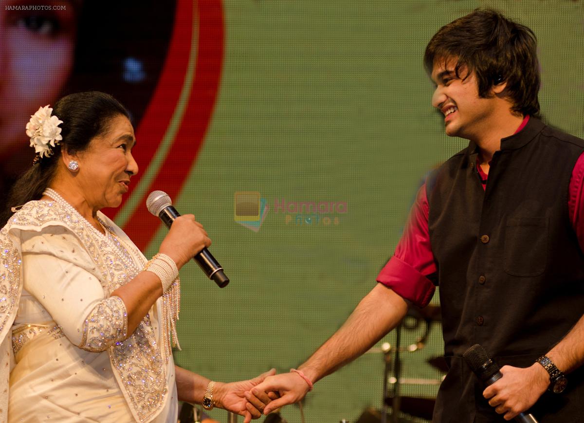 Asha Bhosle and Siddhant Bhosle share a moment at a concert where they performed together