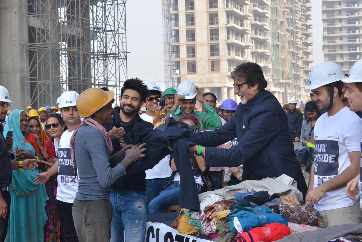 Amitabh Bachchan donating clothes at Gurgaon construction site for Clothes Box Foundation donation