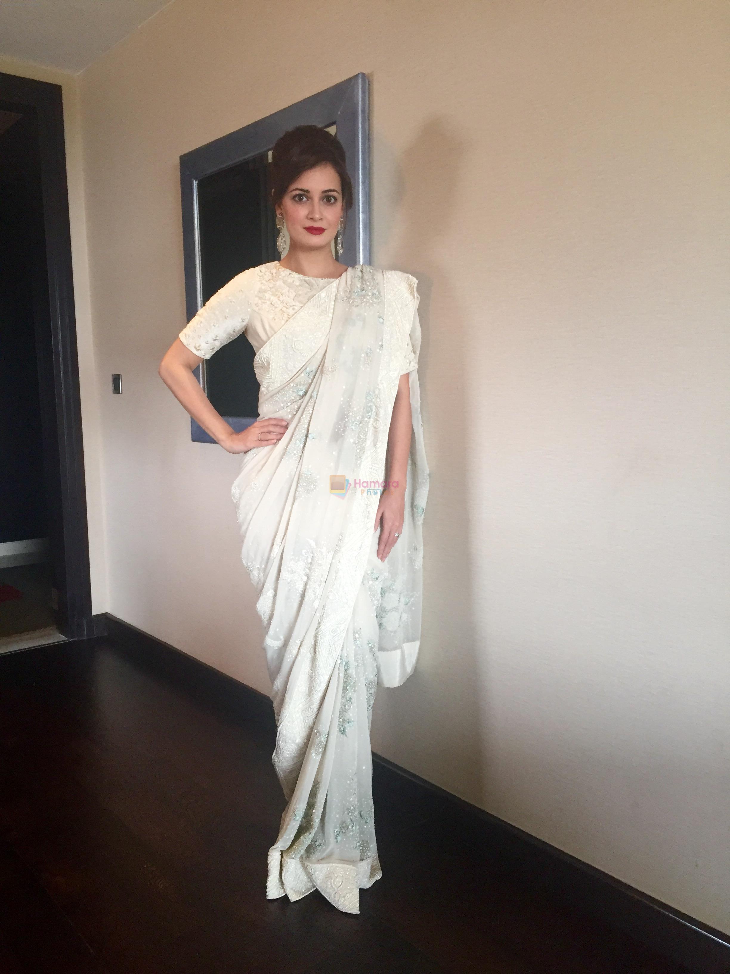 Dia Mirza wearing tone-on-tone ivory sari by Varun Bahl and earrings by Aurelle and a classic red pout