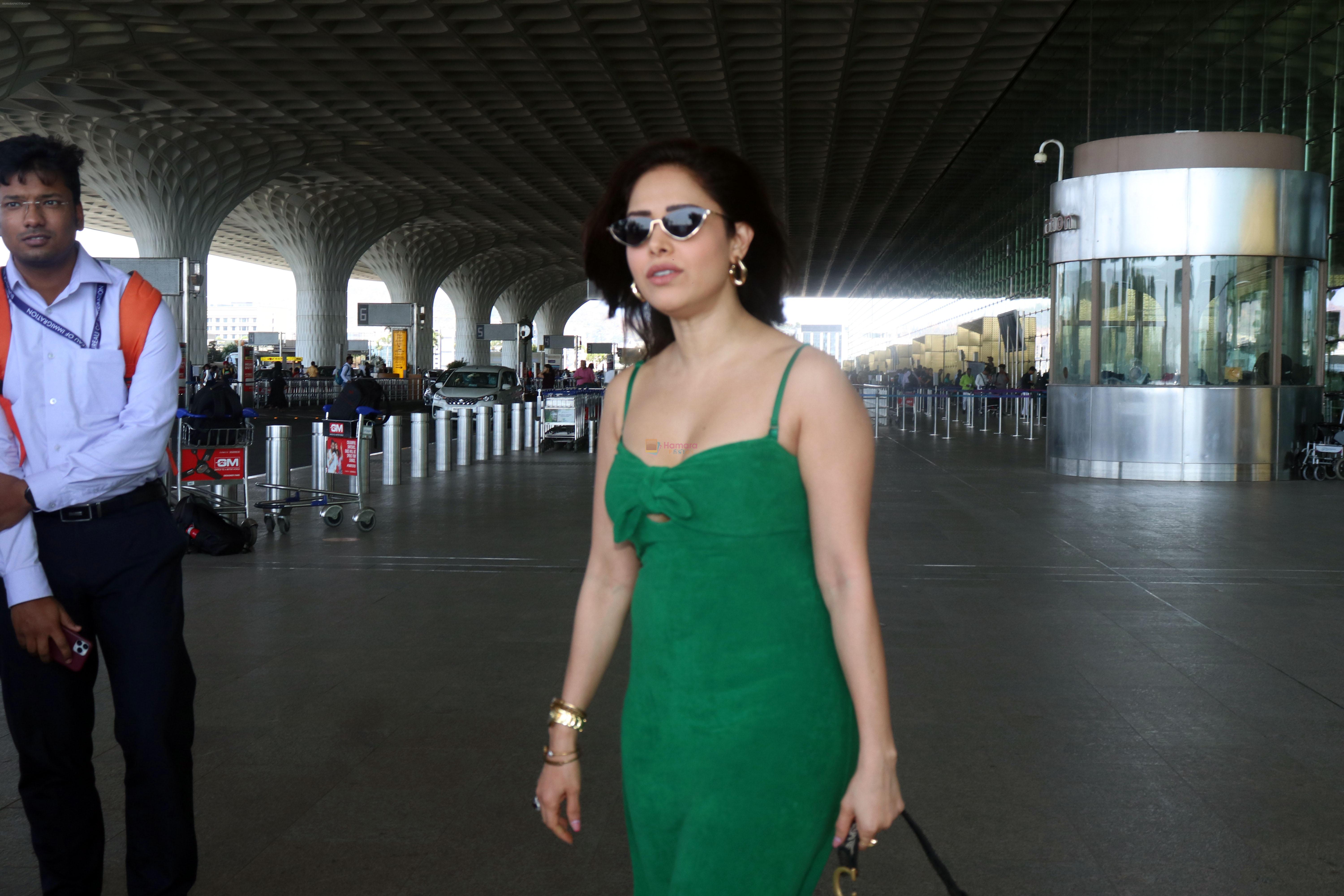 Nushrratt Bharuccha in shoulderless green dress with a tie knot wearing dark shades