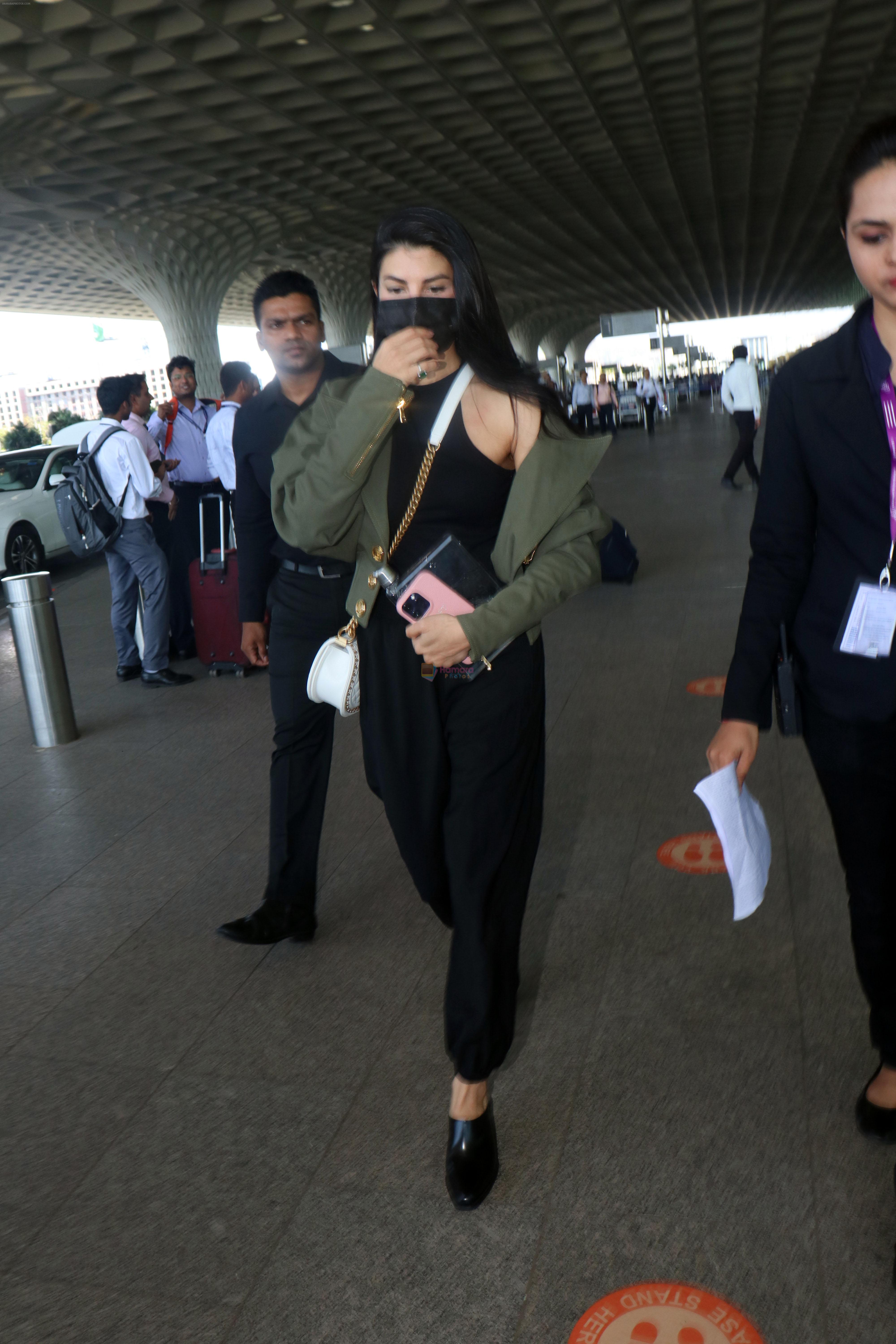 Jacqueline Fernandez in all black wearing a dark green blazer