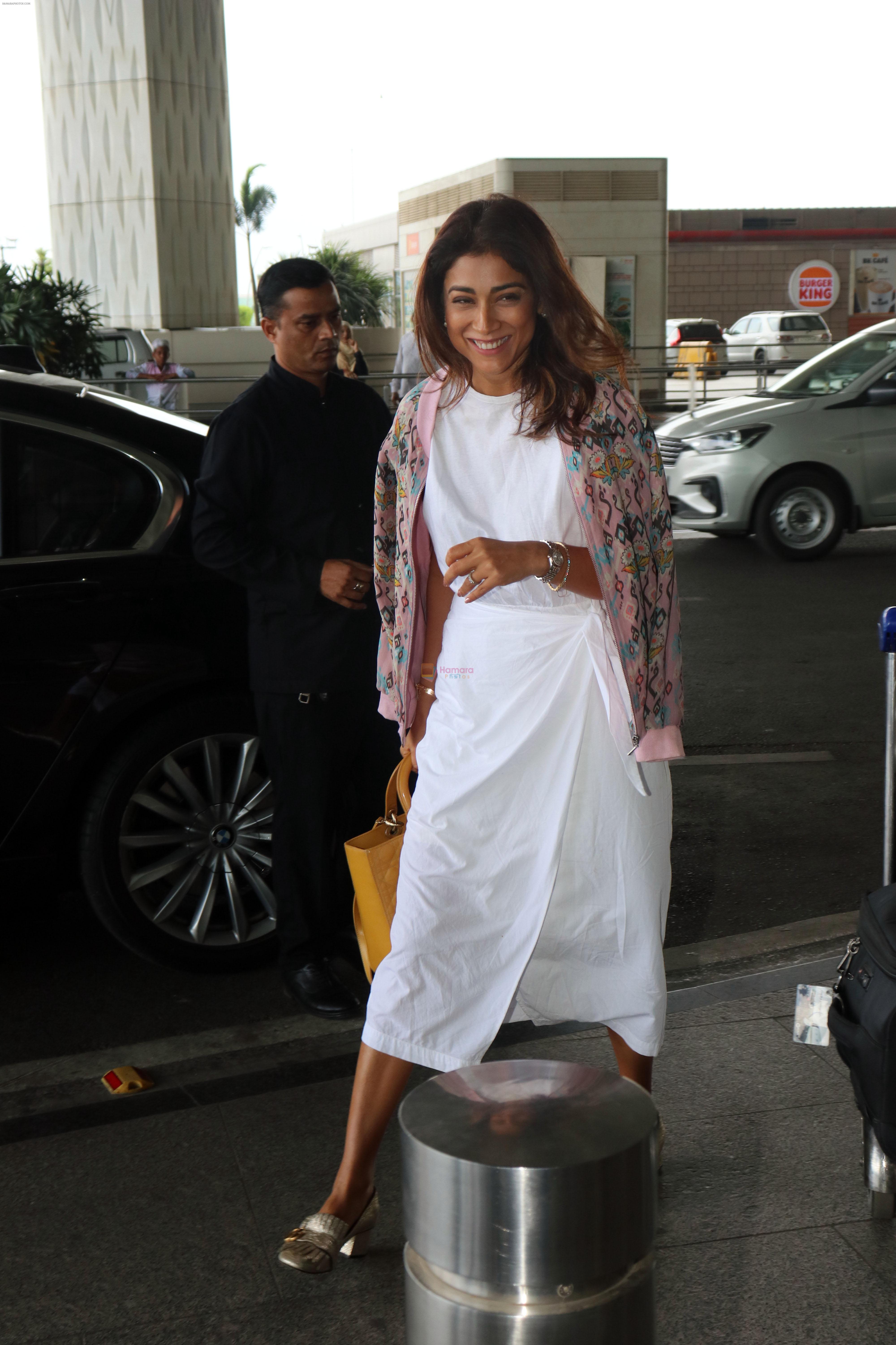 Shriya Saran in a white dress, pink coat design, holding Lady Dior Cannage two-way bag, Gucci Metallic Gold Textured Leather GG Marmont Fringe Detail Heel Pumps