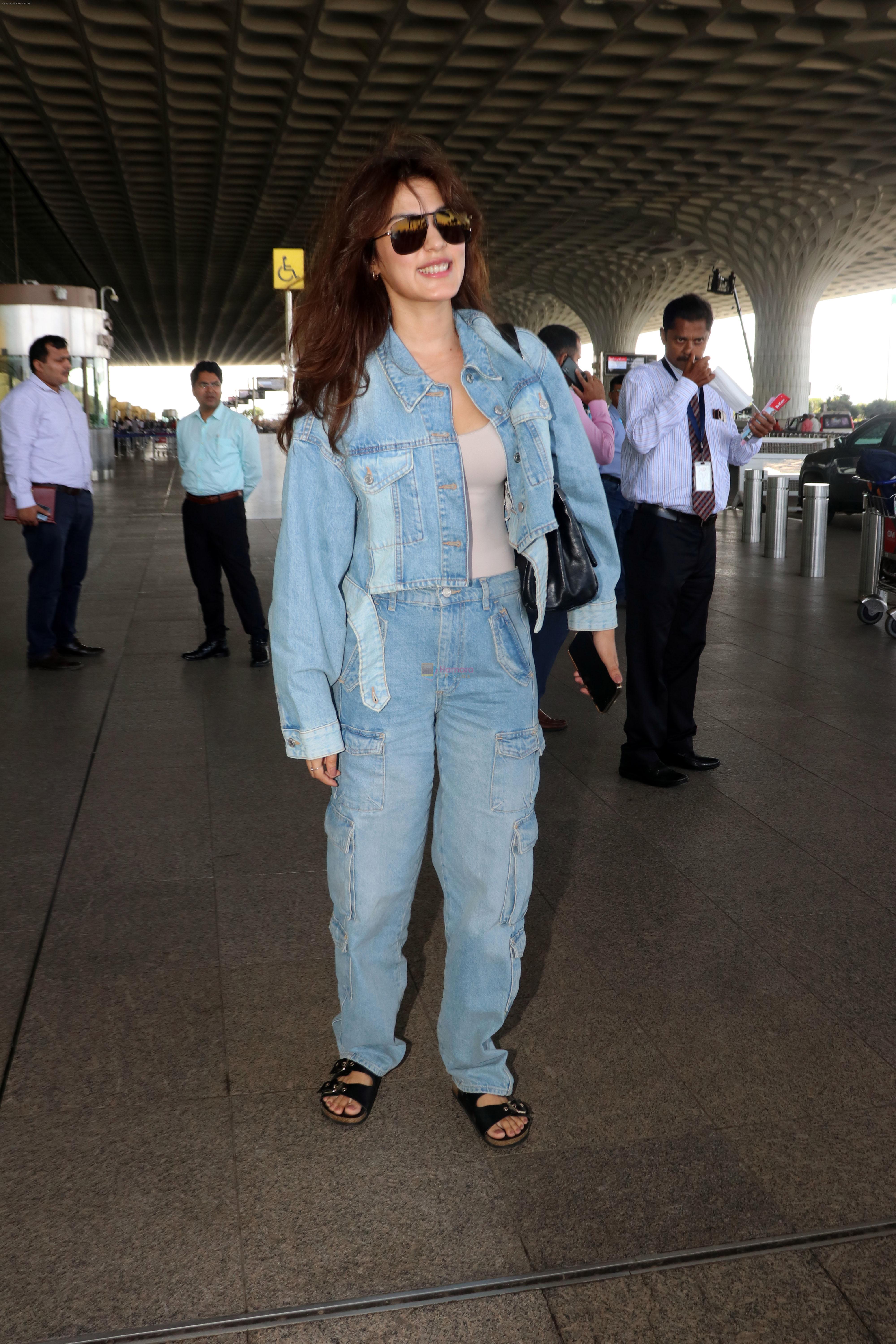 Rhea Chakraborty dressed in Jeans jacket and pant wearing dark glasses and black sandals