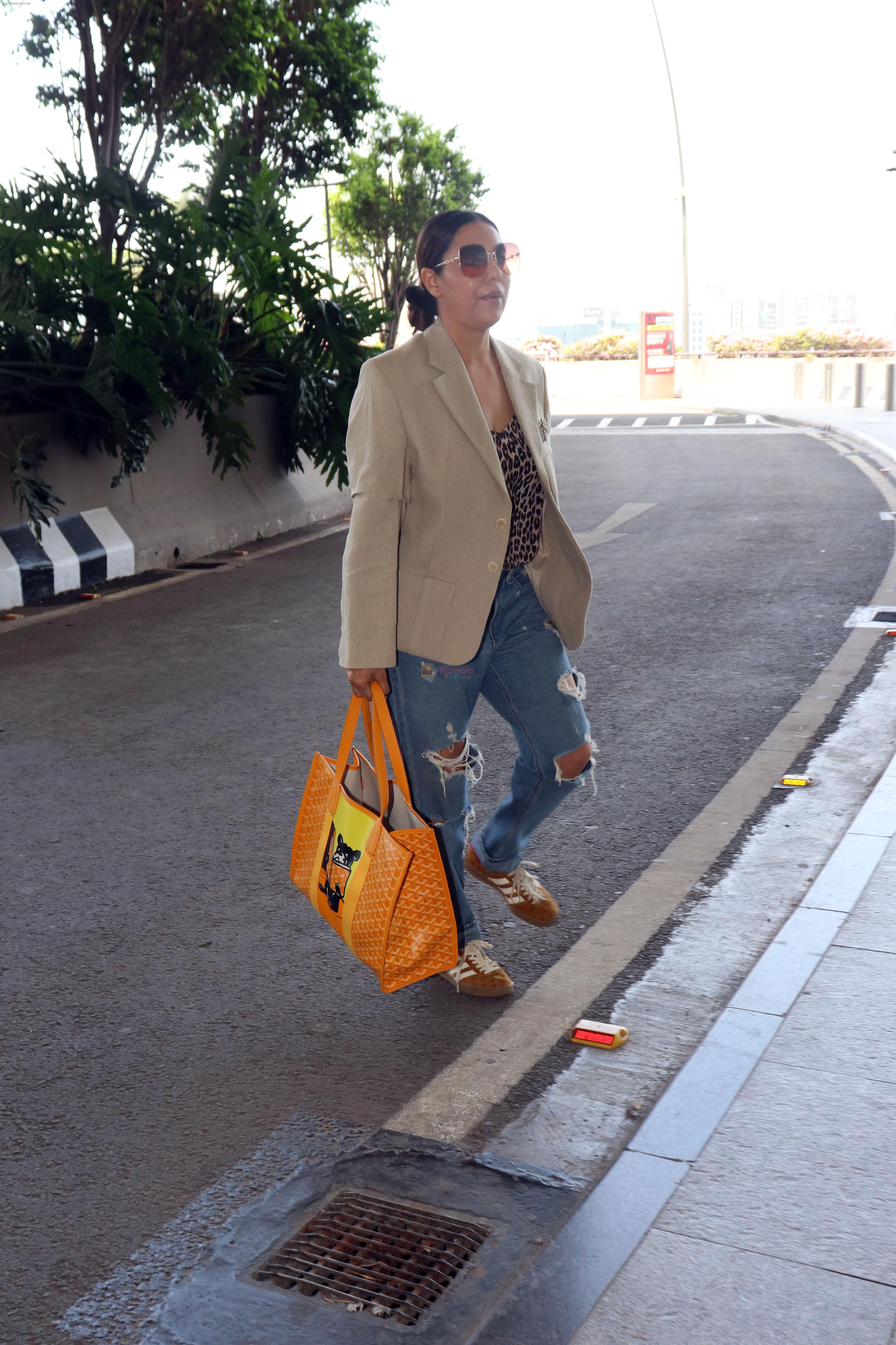 Gauahar Khan holding Villette Tote Bag wearing Gazelle Gucci Mesa White Red shoes, Balmain distressed effect finish jeans, overcoat and sunglasses