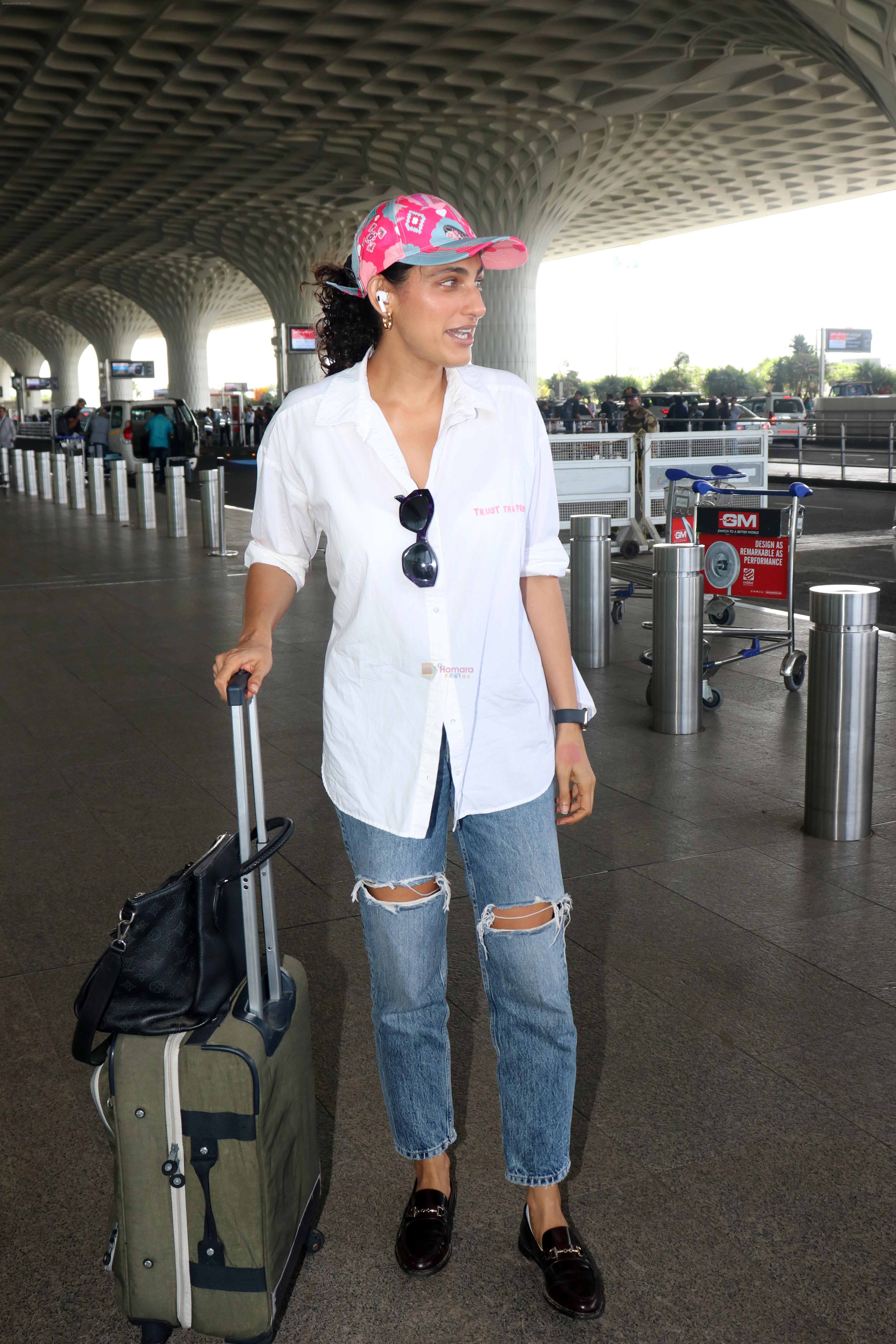 Kubbra Sait in white shirt jeans pant, pink cap wearing Aldo Valenaclya chain loafers in black patent