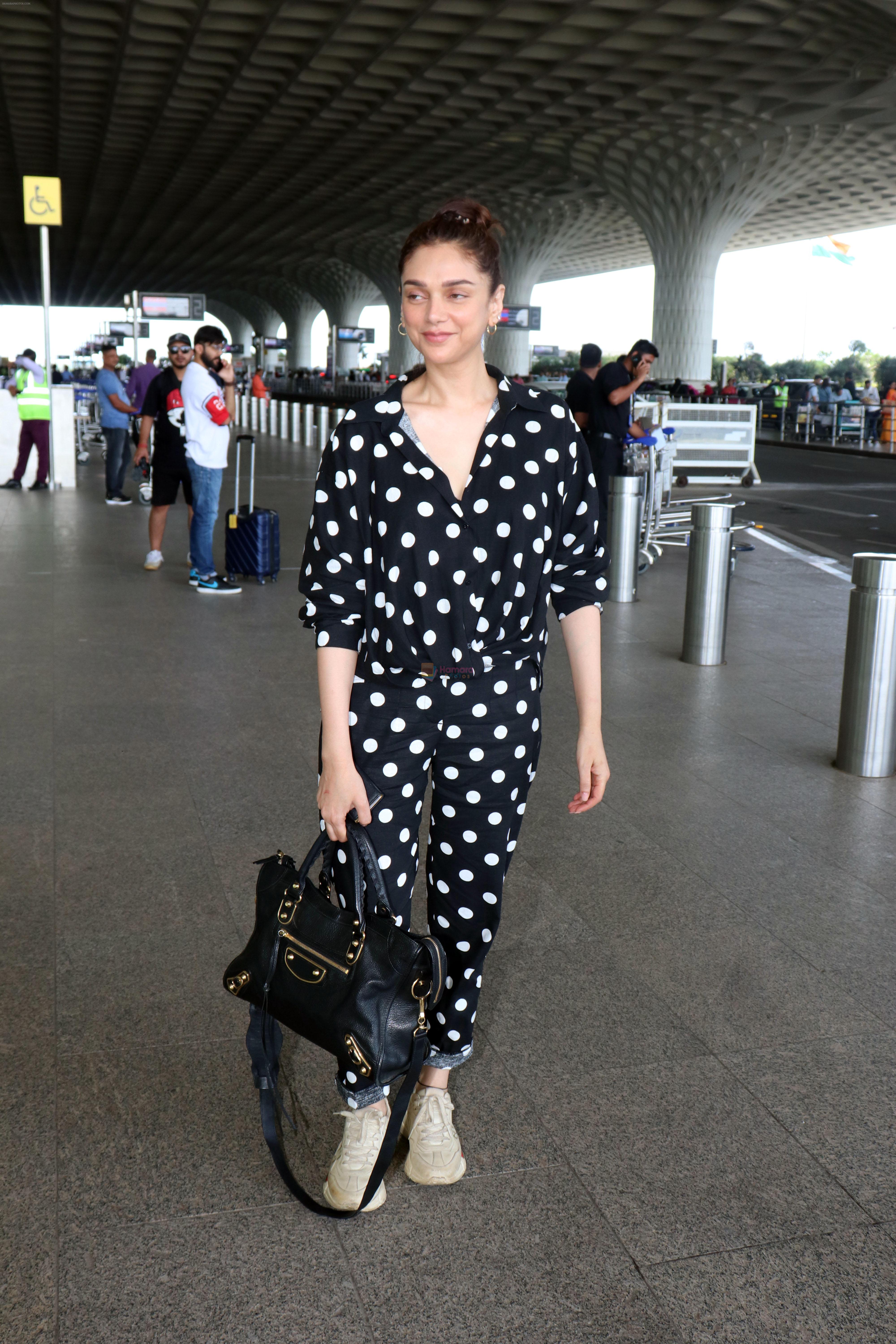 Aditi Rao Hydari holding black leather Balenciaga handbag wearing Polka Dots Richie Freeman outfit and Gucci Leather sneakers