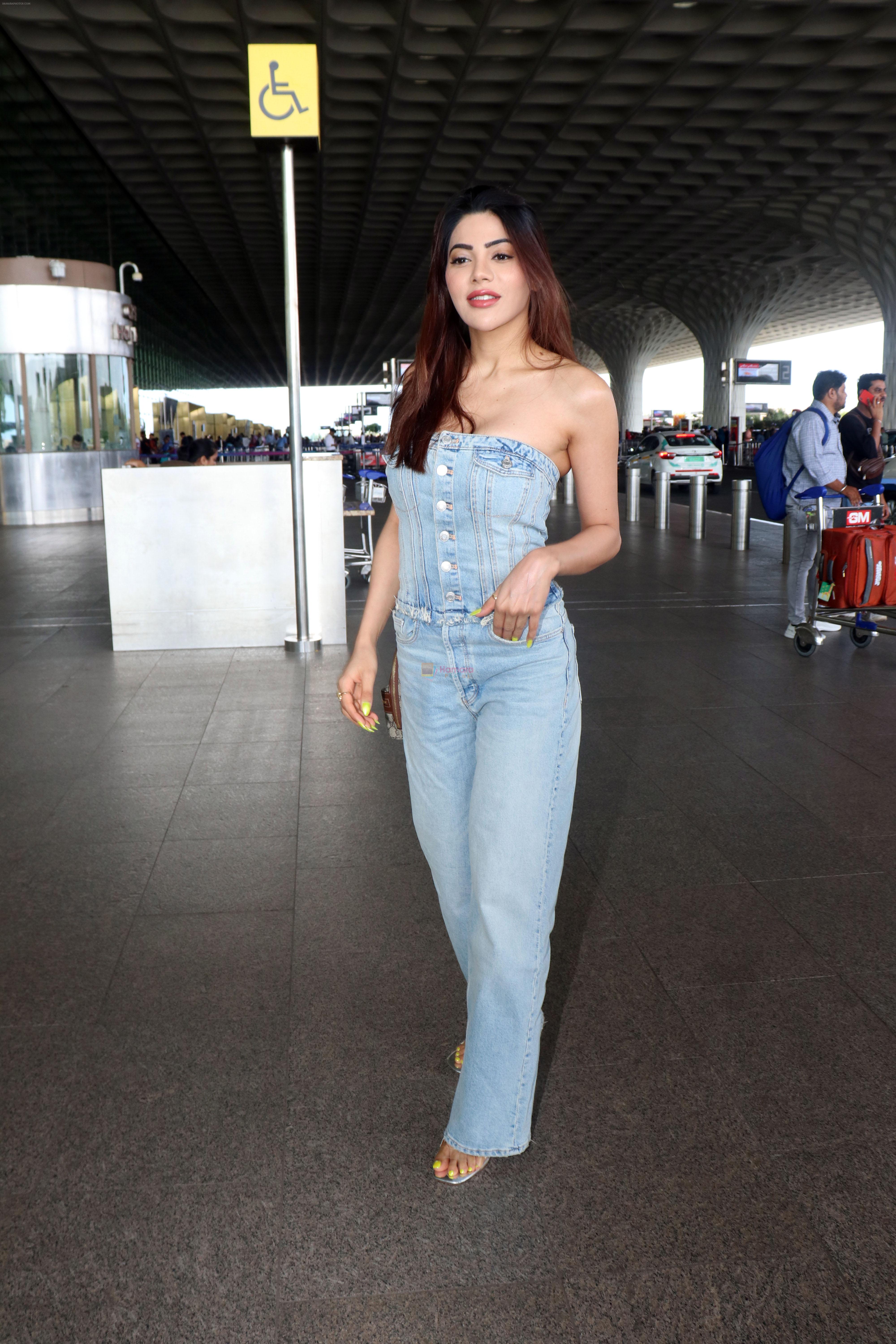 Nikki Tamboli dressed in Jeans top and pant holding Gucci Ophidia Small handbag