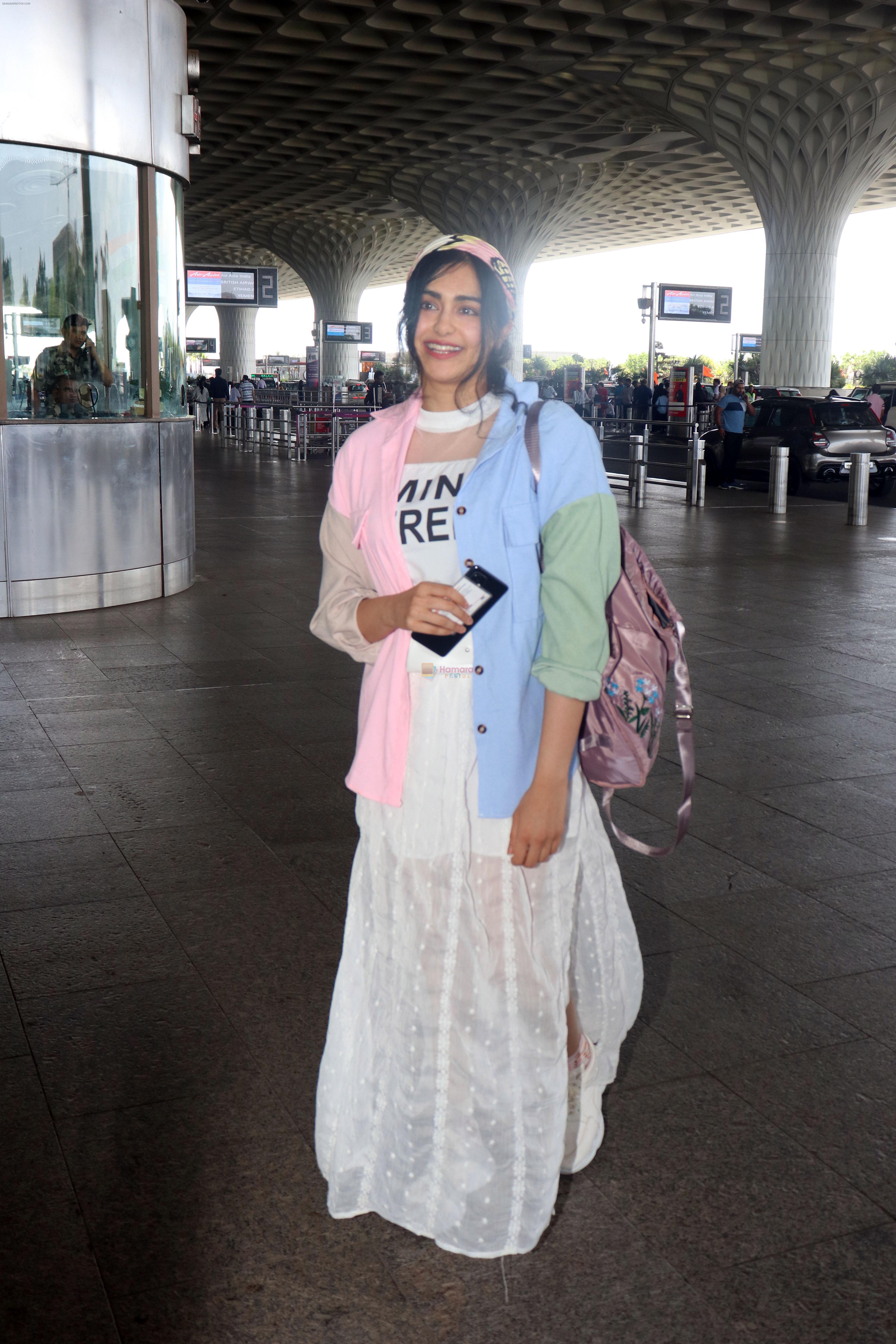 Adah Sharma holding travel folding bag dressed in an urbanic patchwork placket bouse and transparent skirt