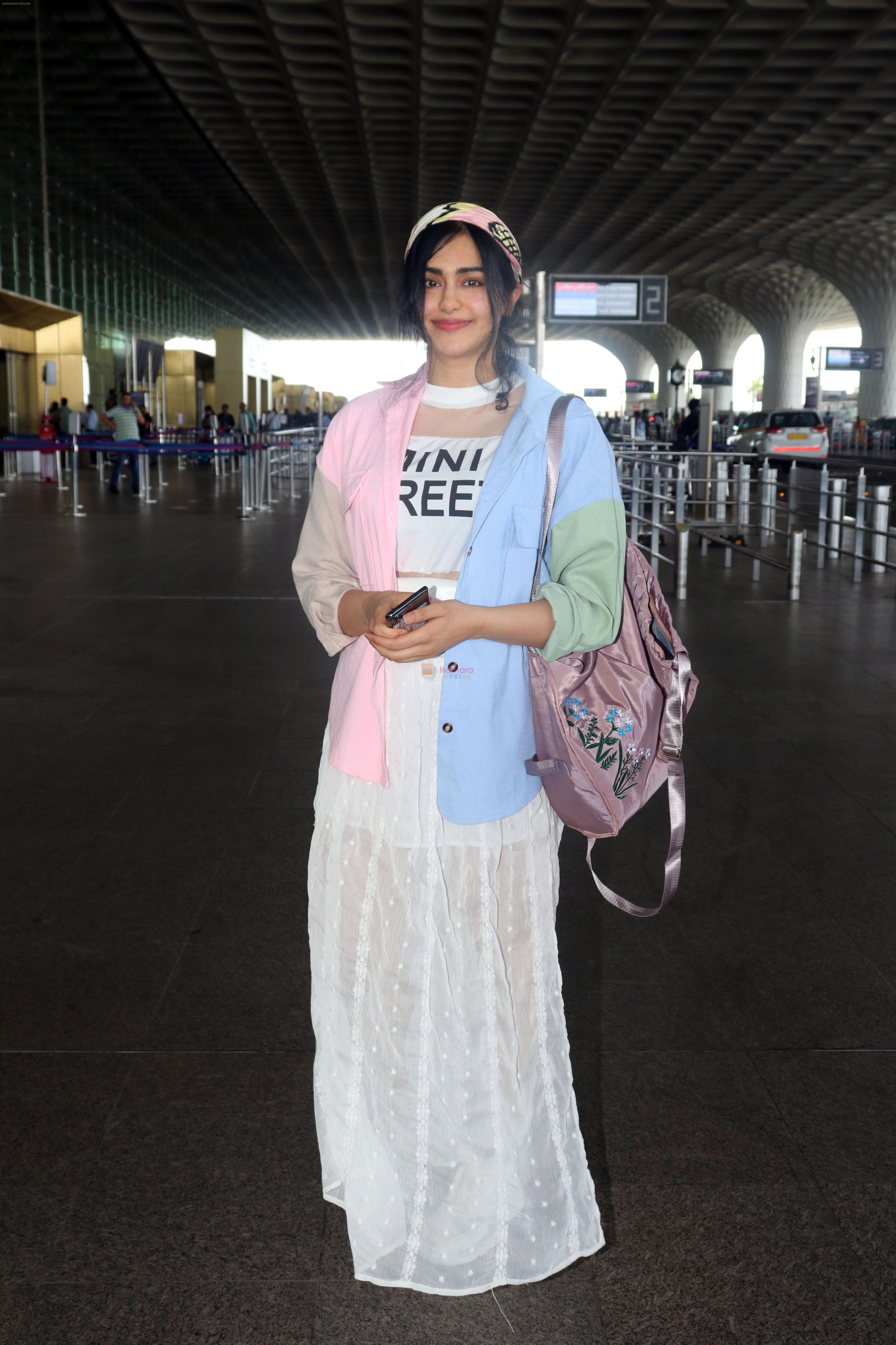 Adah Sharma holding travel folding bag dressed in an urbanic patchwork placket bouse and transparent skirt