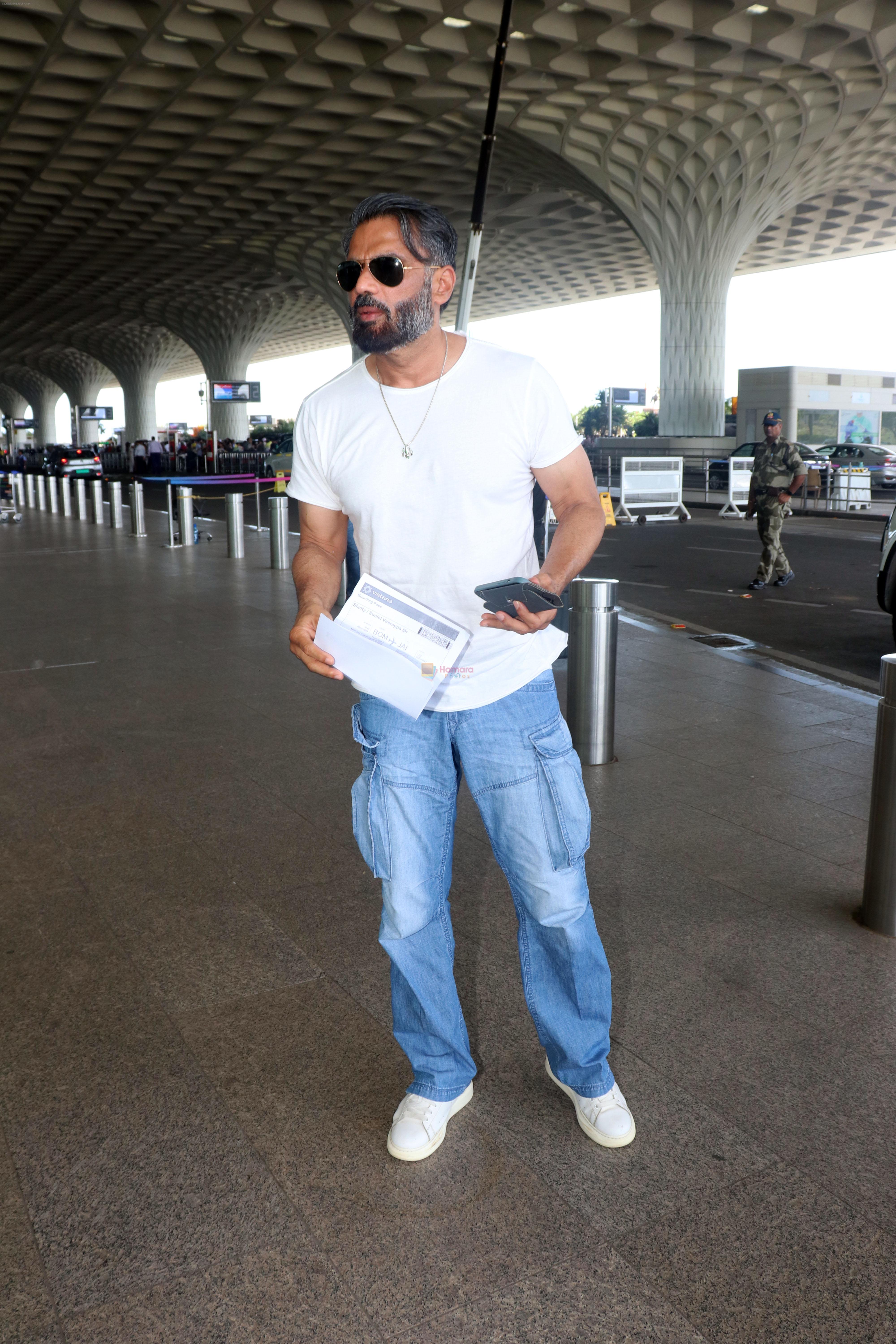 Suniel Shetty wearing white tshirt and baggy blue jeans