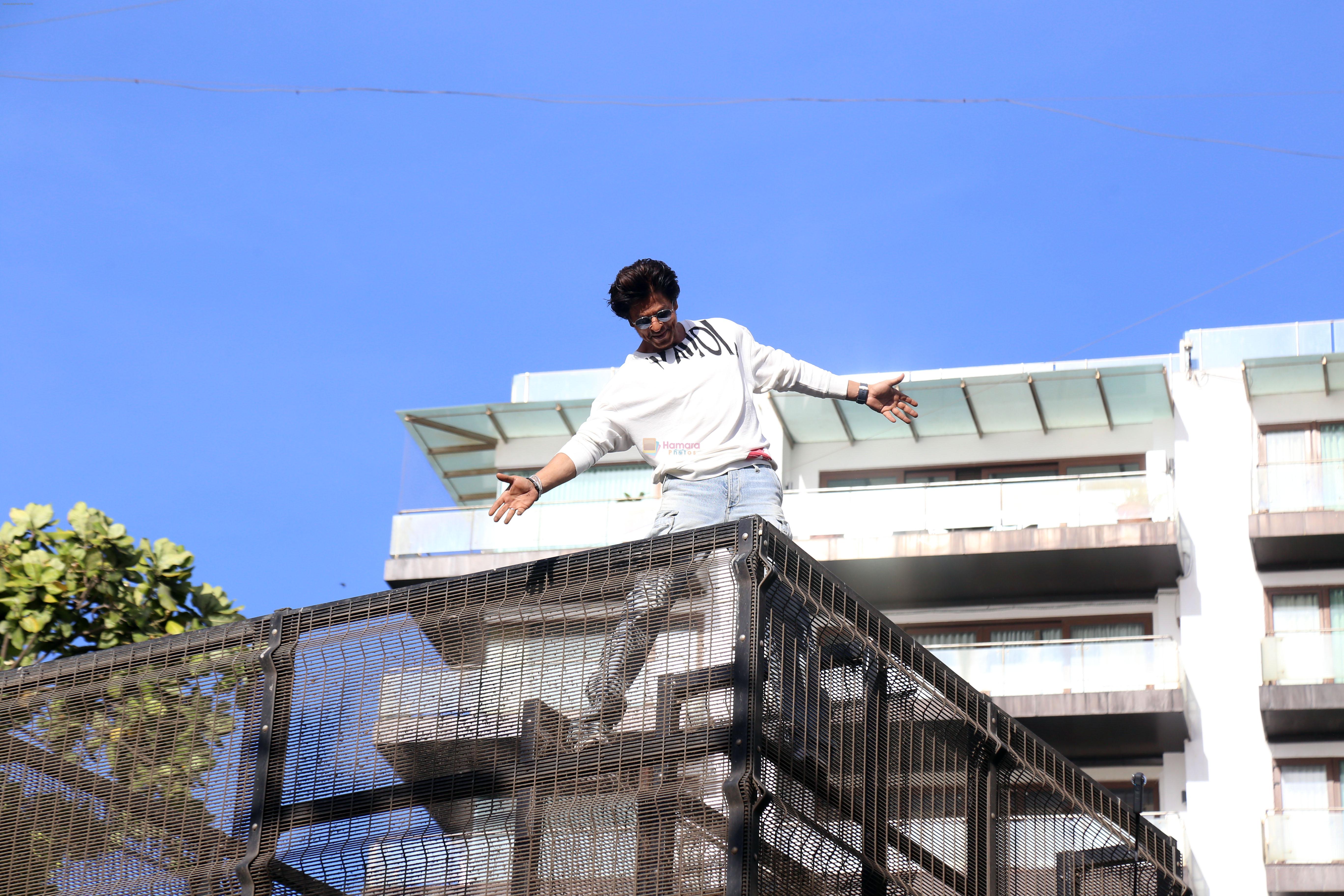 Shah Rukh Khan pose in celebration of the world TV premiere of his film Pathan