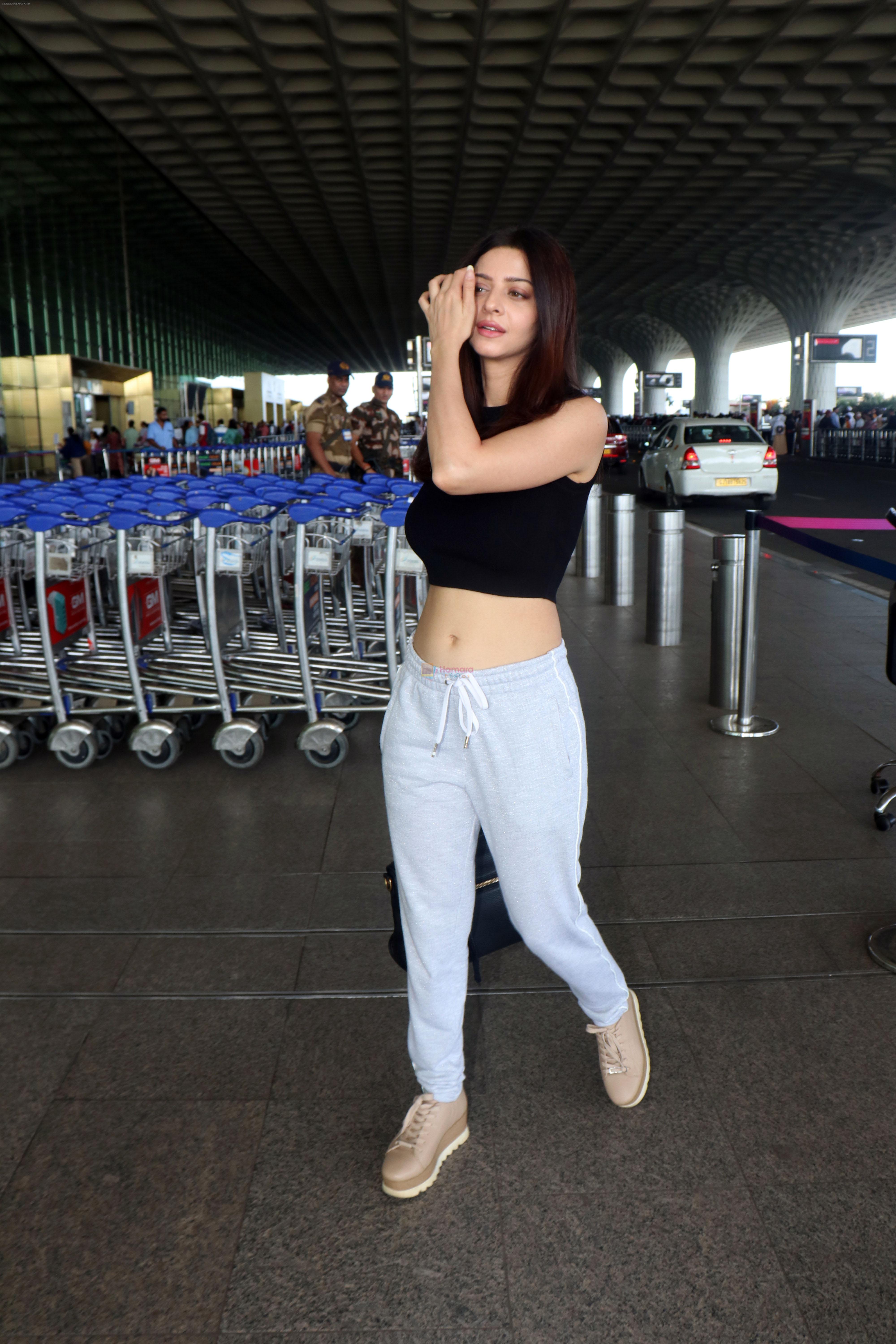 Vedhika Kumar travelling wearing Black sleeveless top and sweat pant carrying a leather handbag