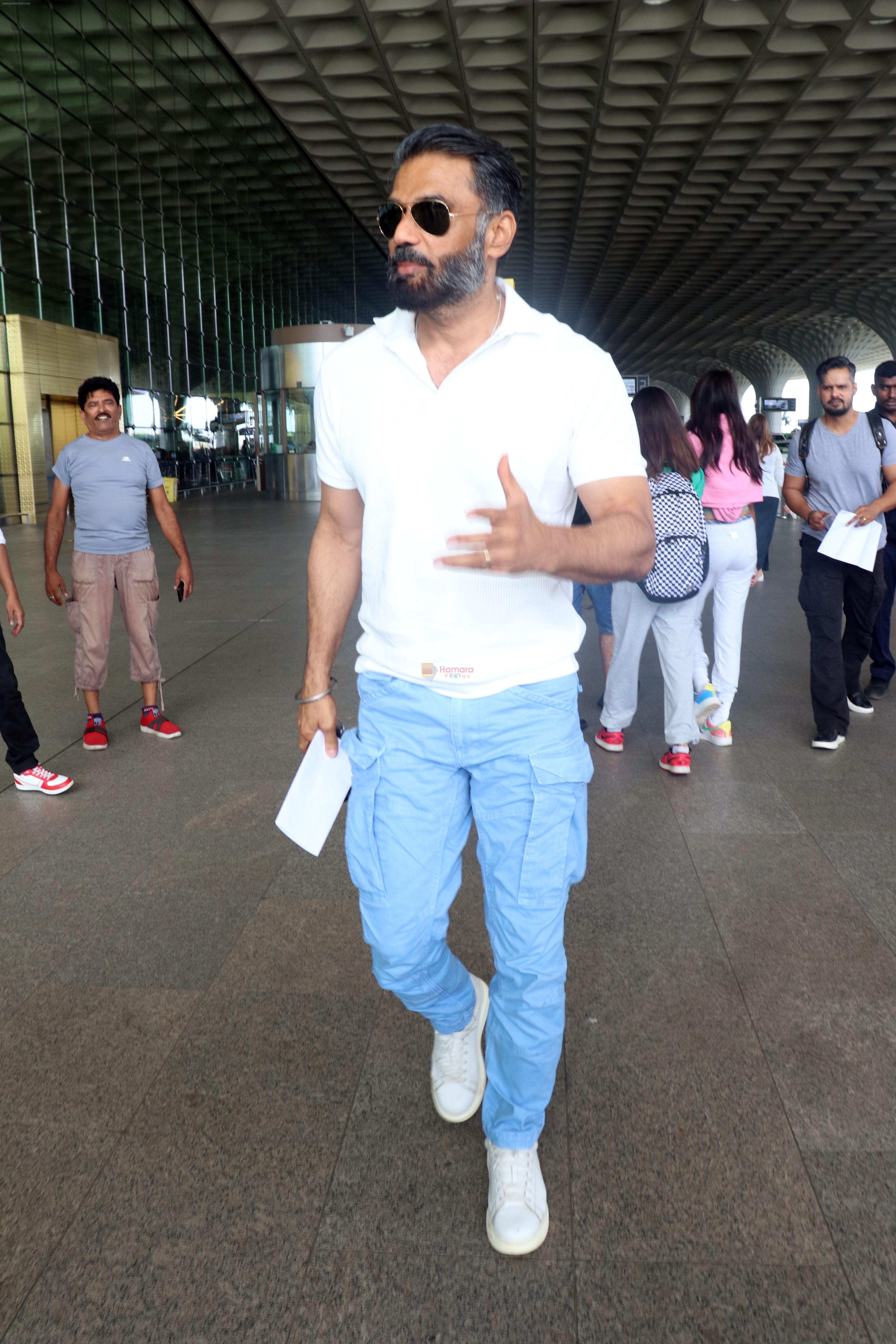 Suniel Shetty seen in white and blue casuals at the airport on 23 Jun 2023