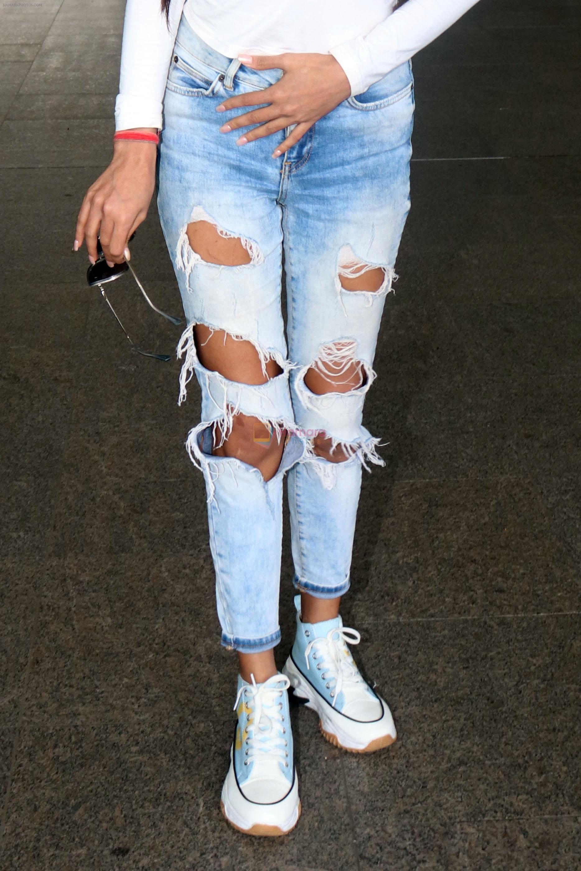 Poonam Pandey in white Cest La Vie Paris t-shirt and blue shredded jeans seen at the airport on 1 July 2023