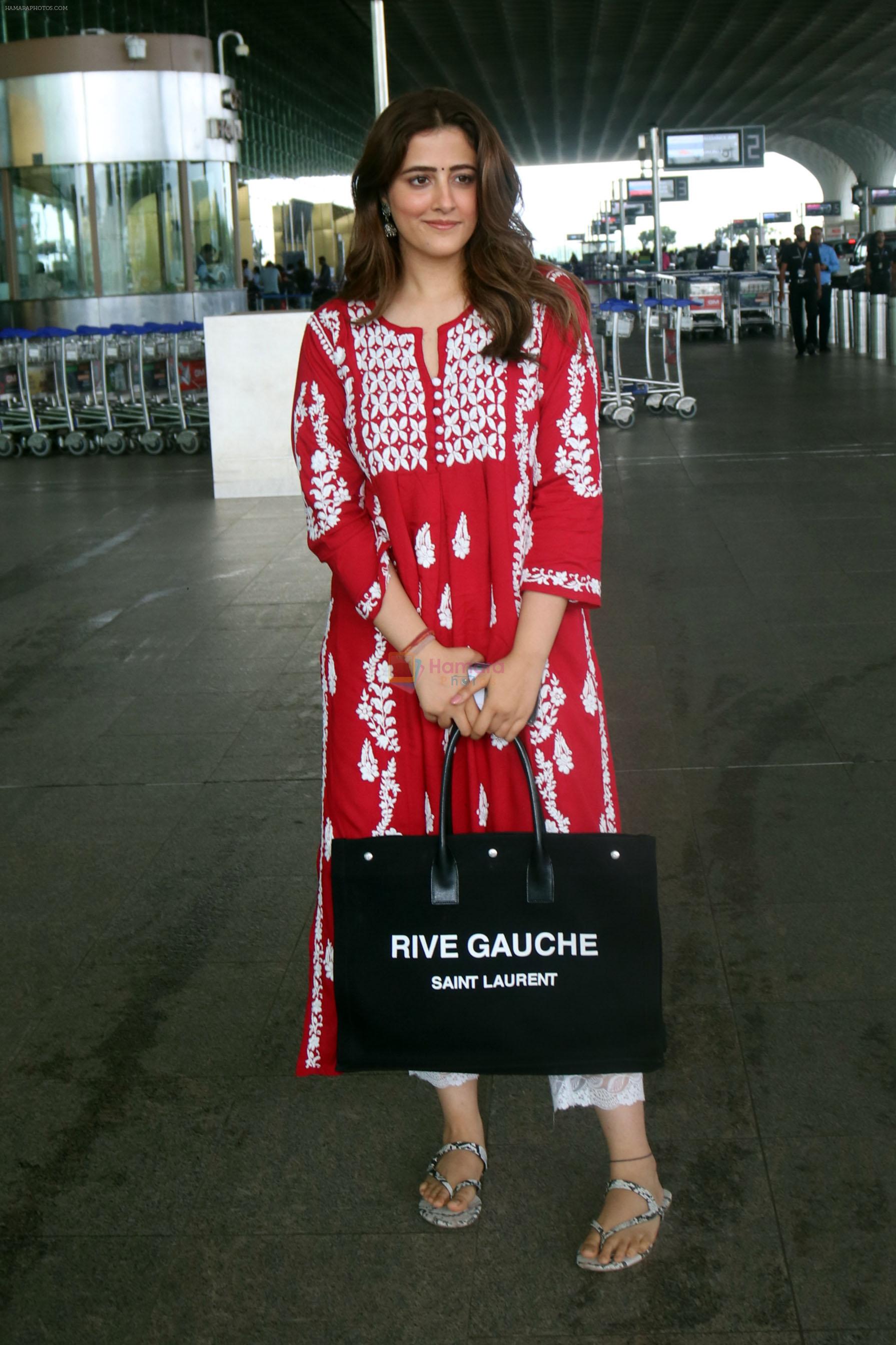 Nupur Sanon seen shinnig in red at the airport holding Saint Laurent handbag on 9 July 2023